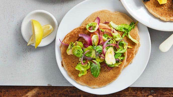 Shaved Brussels Sprouts pancakes on a white plate