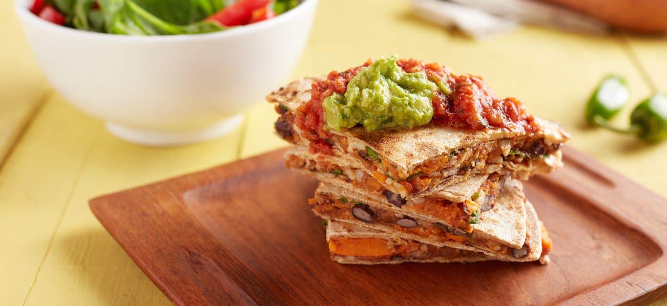 sweet potato quesadilla topped with guacamole - one of many plant based recipes